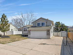 Multi-level home featuring west-facing concrete driveway, RV Parking, 2-car Garage & RV Parking