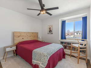 Bedroom with LVP Floors, ceiling fan & Bookshelves