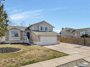 Multi-level home featuring west-facing concrete driveway, 2-car Garage & RV Parking