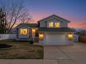 Multi-level home featuring west-facing concrete driveway, 2-car Garage & RV Parking