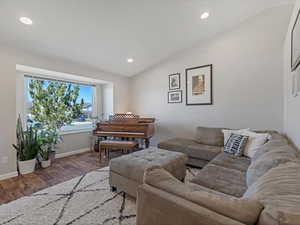 Living area with Vaulted Ceilings, LVP Flooring & Recessed Lighting