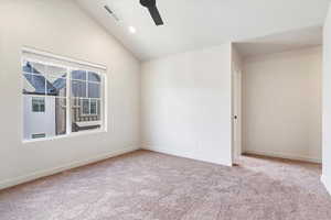 Unfurnished room featuring lofted ceiling, a ceiling fan, light carpet, and recessed lighting