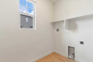 Laundry room featuring electric dryer hookup, light wood-type flooring, and hookup for a washing machine