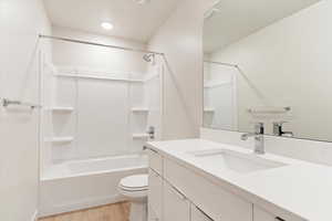 Full bath featuring vanity, light wood-style floors, and tub / shower combination