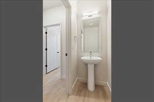 Bathroom featuring light wood-type flooring and baseboards