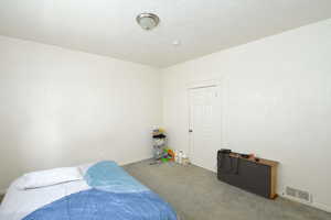 Bedroom featuring carpet floors and baseboards