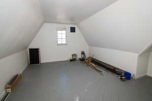 Bonus room with baseboards and hardwood / wood-style floors