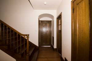Entrance foyer with dark wood-style flooring and arched walkways