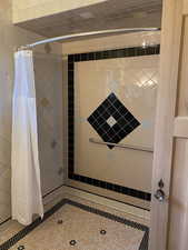 Full bathroom featuring a stall shower