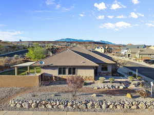 View of front of property with stucco siding, stone siding, a mountain view, and a residential view