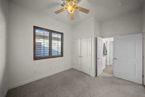 Unfurnished bedroom featuring carpet, a closet, and ceiling fan