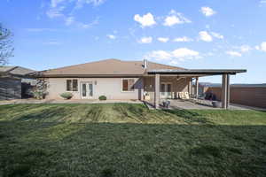 Back of house featuring french doors, a fenced backyard, and a patio area