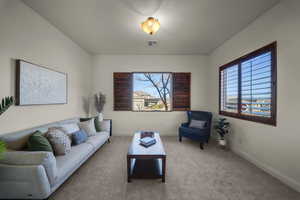 Living room featuring carpet and baseboards