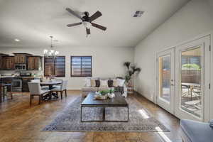 Living area featuring ceiling fan, french doors, and suspended lighting