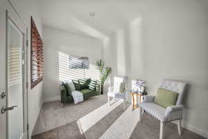 Sitting room featuring carpet floors and baseboards