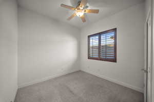Spare room with carpet and ceiling fan