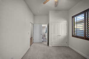 Unfurnished bedroom with light carpet, a closet, and ceiling fan