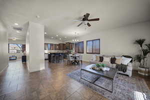 Living area with ceiling fan and suspended lighting