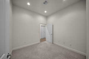 Unfurnished room with carpet floors and recessed lighting