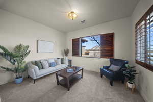 Carpeted living room with baseboards
