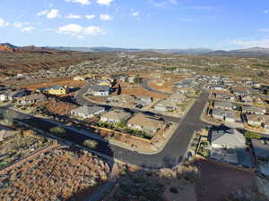 Aerial overview of property's location featuring a mountain backdrop and nearby suburban area