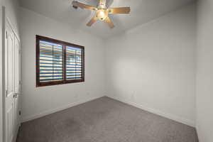 Unfurnished bedroom featuring carpet, a ceiling fan, and a closet