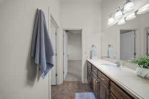 Bathroom with vanity and dark stone finish flooring