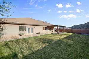 Back of property with stucco siding, a patio, a fenced backyard, and french doors