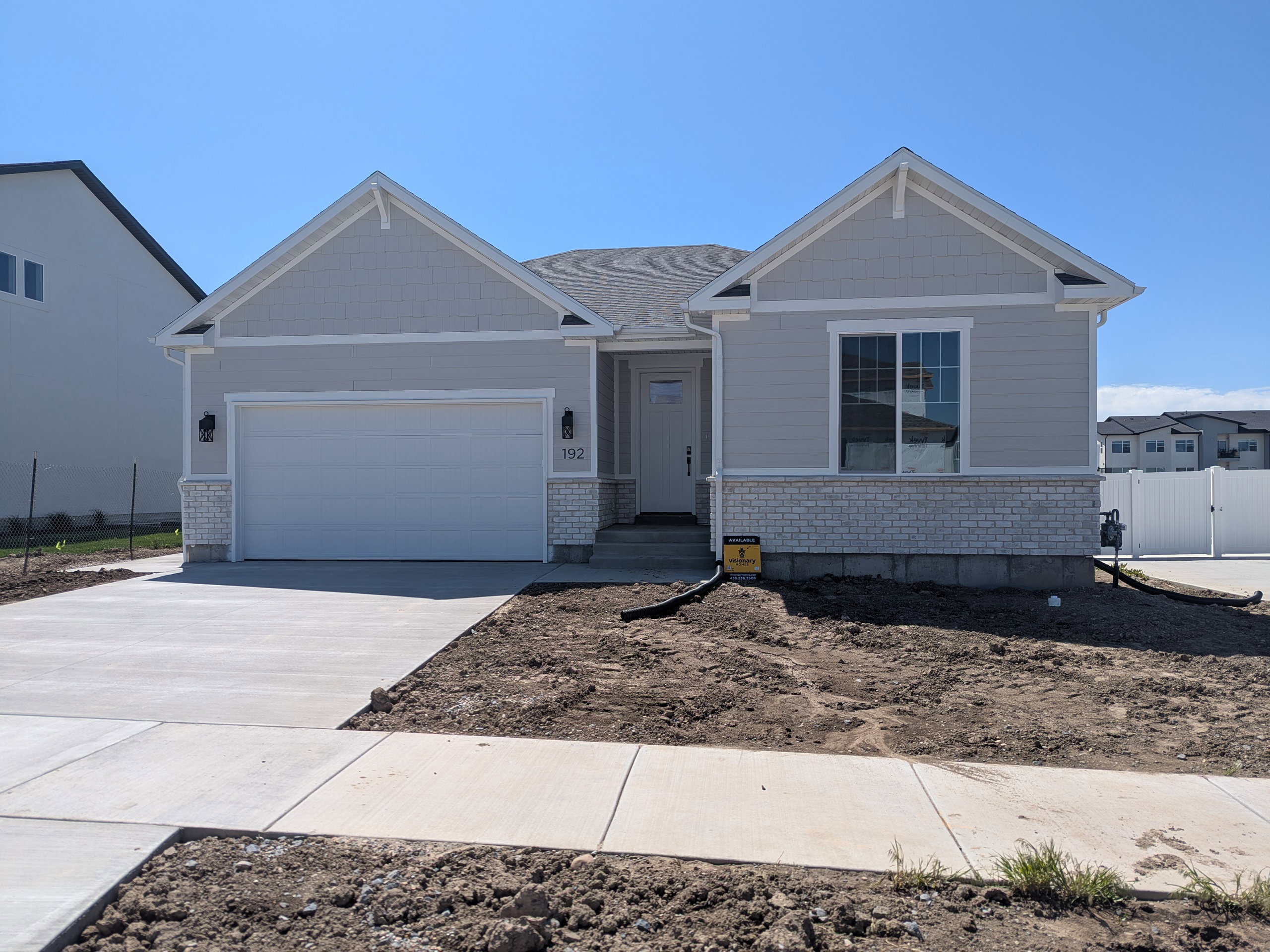 Craftsman-style home with an attached garage and concrete driveway