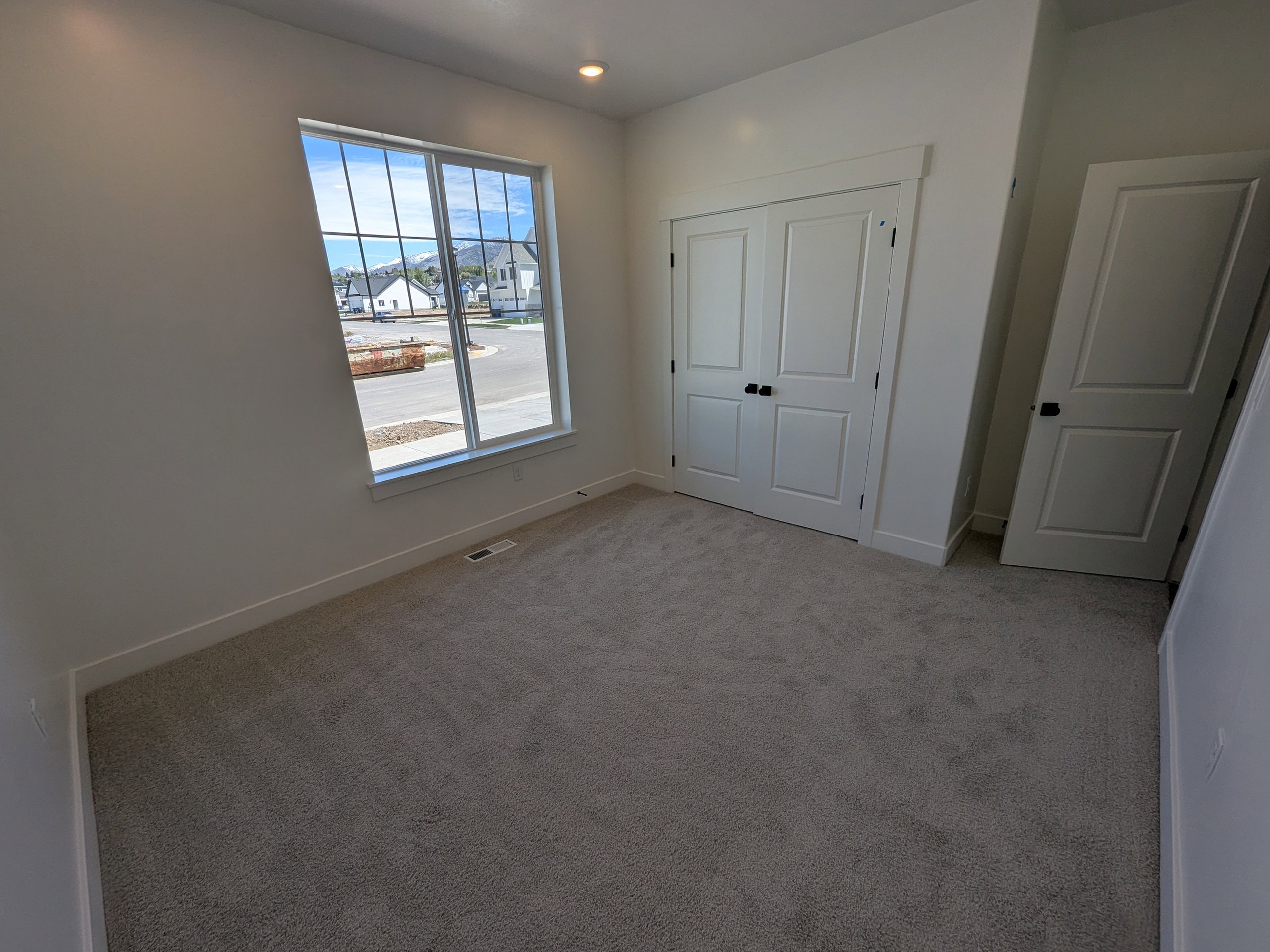 Unfurnished bedroom featuring light carpet, a closet, and recessed lighting