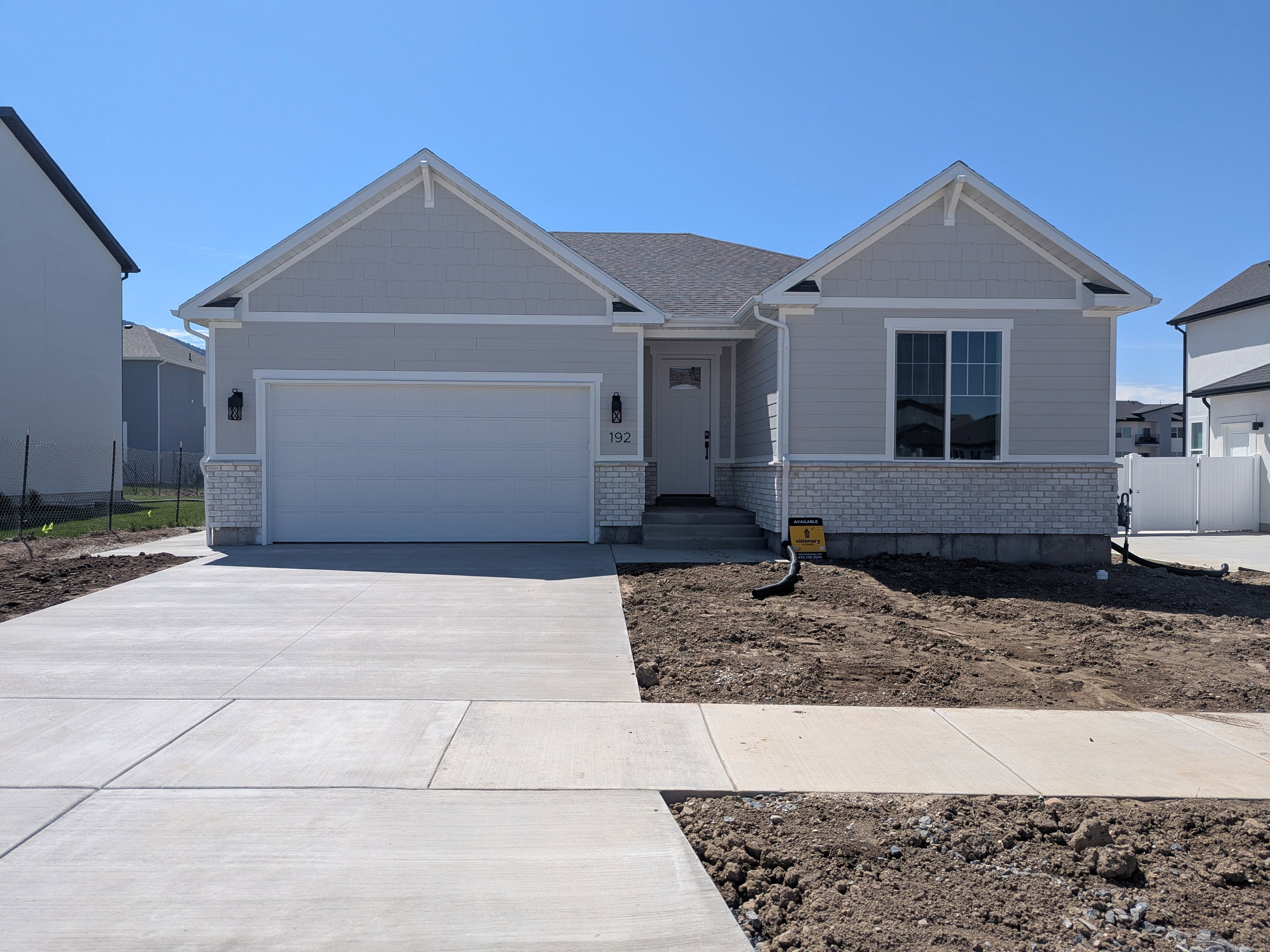 View of front facade featuring a garage and driveway