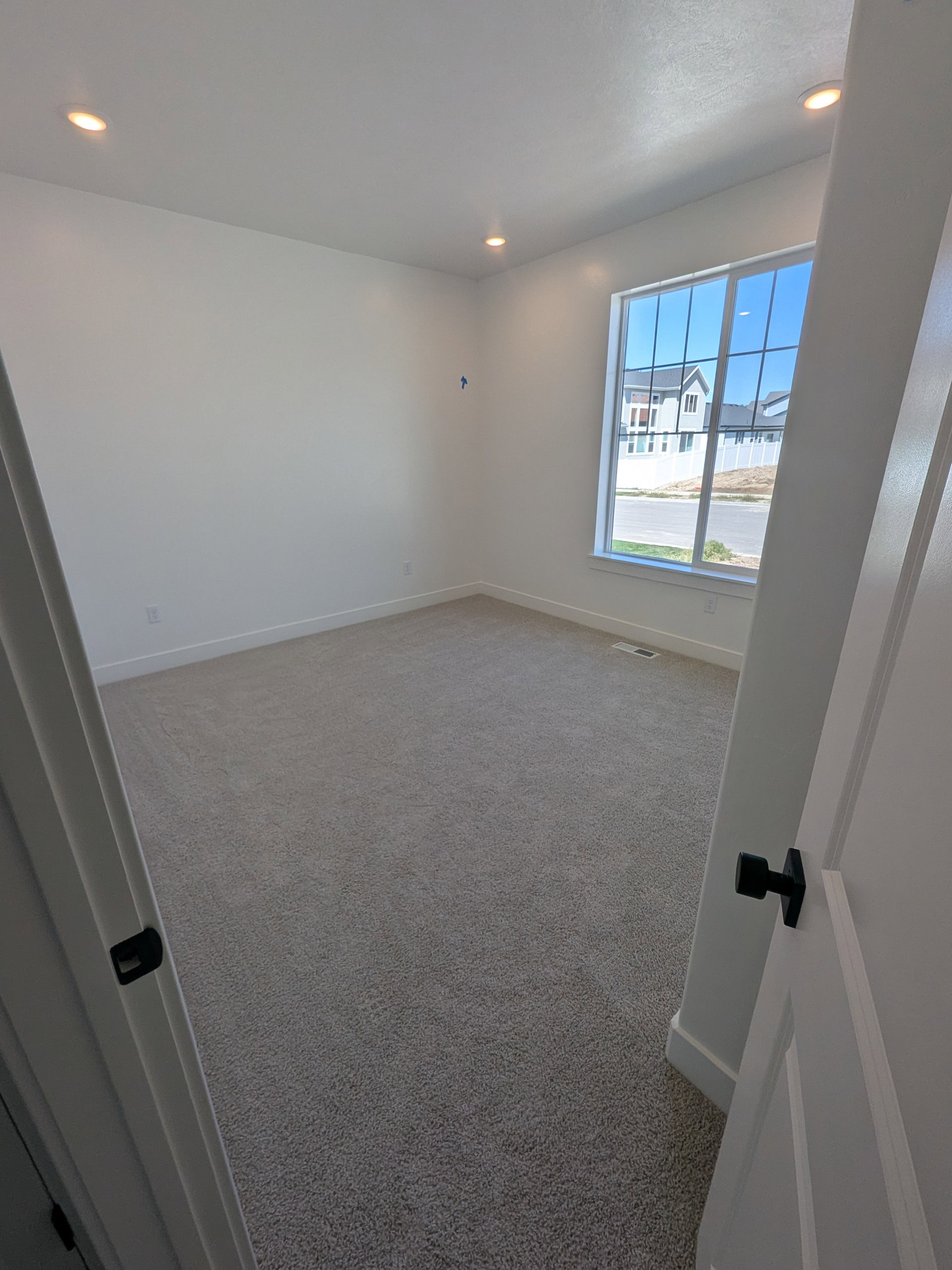 Carpeted empty room featuring recessed lighting