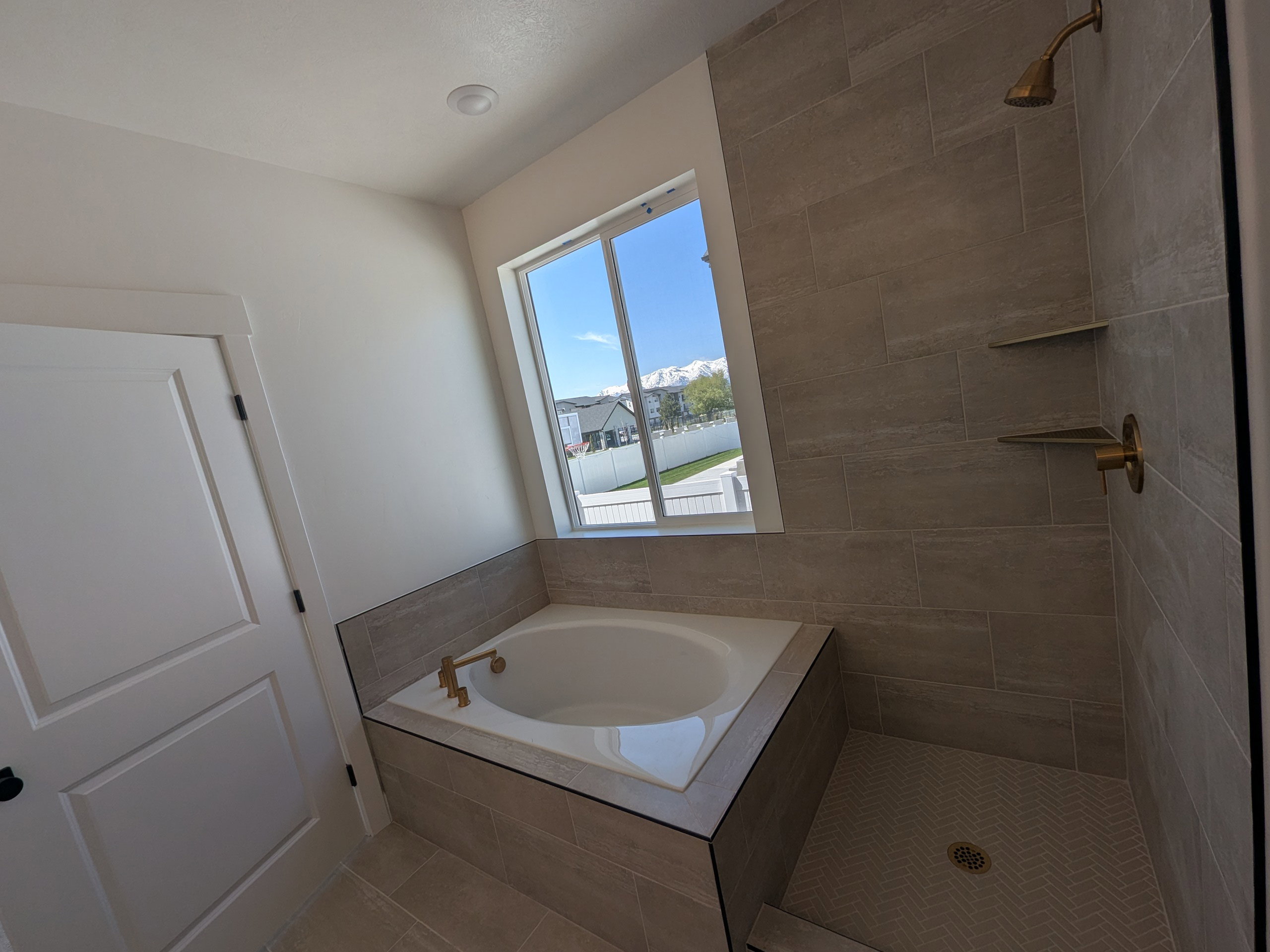 Full bathroom featuring a garden tub, a shower stall, and tile patterned flooring