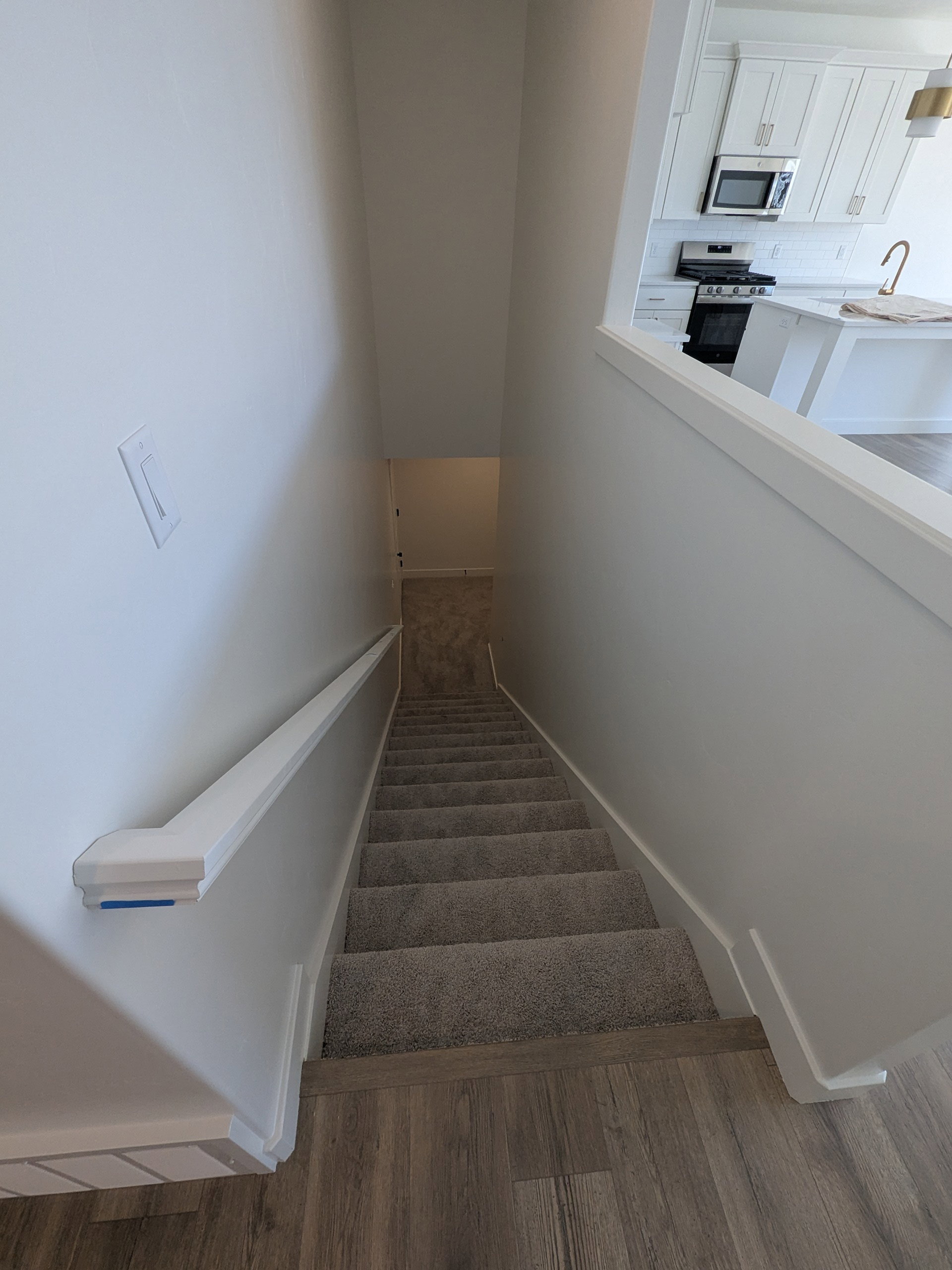 Staircase with wood finished floors and baseboards