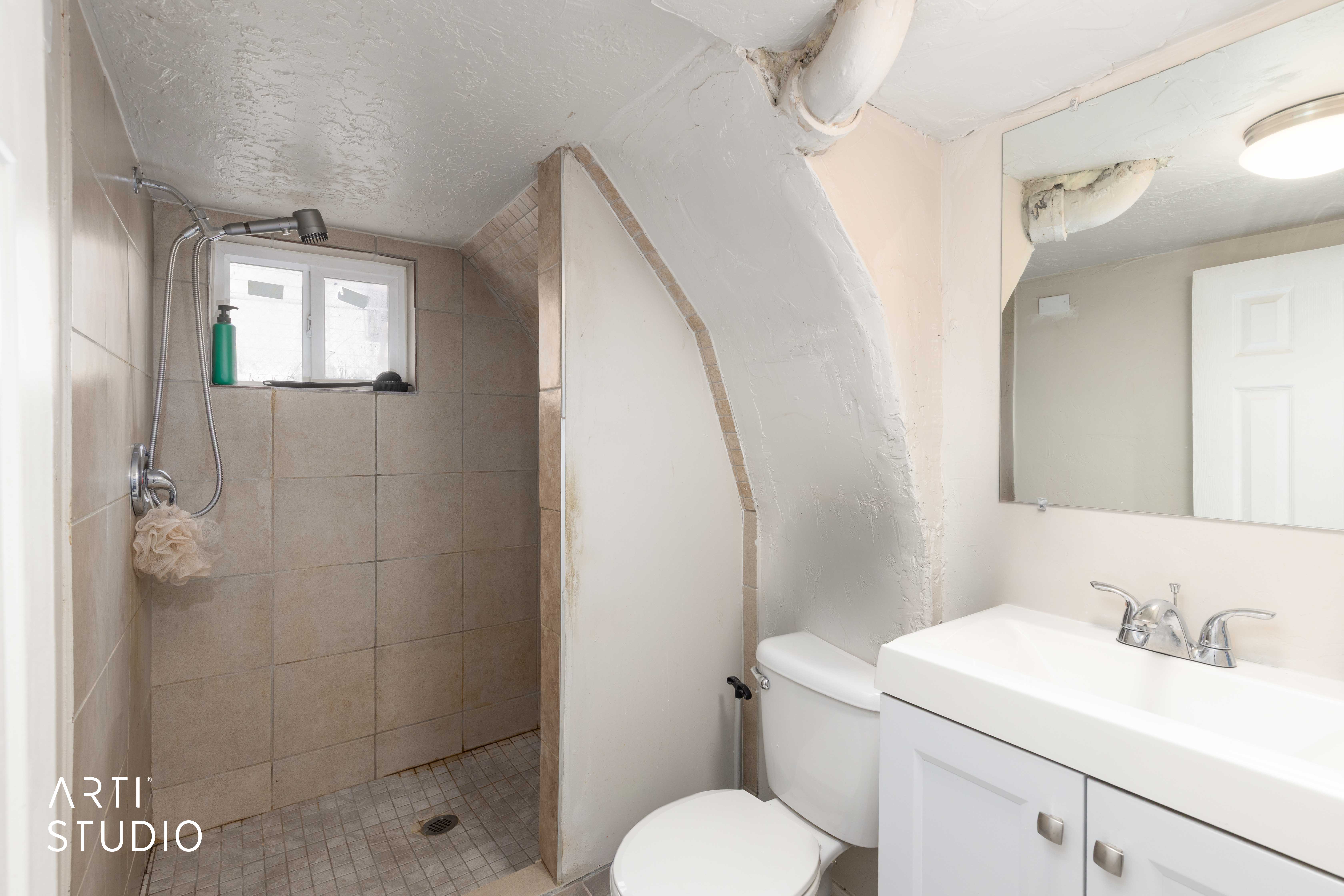 Bathroom featuring vanity, a textured ceiling, and tiled shower