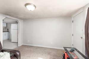 Workout room with arched walkways and light colored carpet