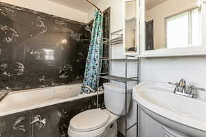 Full bathroom featuring toilet and shower / tub combo