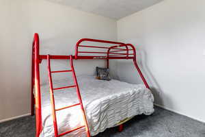 Bedroom featuring dark carpet