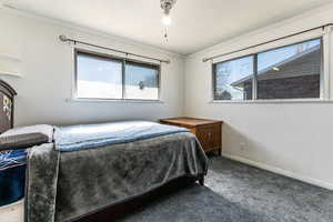 Carpeted bedroom with ornamental molding and a textured ceiling