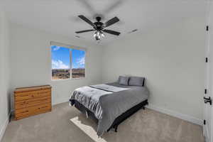 Bedroom with light colored carpet and ceiling fan