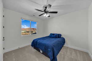 Bedroom with light carpet and ceiling fan