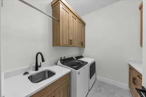 Laundry area with washer and dryer and cabinet space