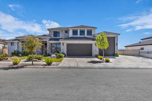 Prairie-style home featuring driveway, a garage, and stucco siding