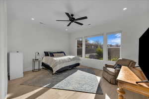 Bedroom featuring light wood-type flooring, a ceiling fan, and recessed lighting