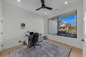Home office featuring a ceiling fan, light wood-style floors, and recessed lighting