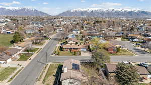 Aerial view of property's location with nearby suburban area and a mountain backdrop