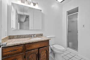 Full bathroom with vanity, a shower stall, and light tile patterned flooring