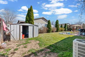 View of yard with a storage unit, a patio, and a gazebo