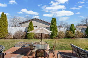 Fenced backyard featuring outdoor dining area, a patio area, and grilling area