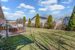 Fenced backyard with a patio